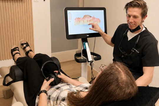 Dr. Joshua Helmstadter reviewing dental imaging on a computer monitor.